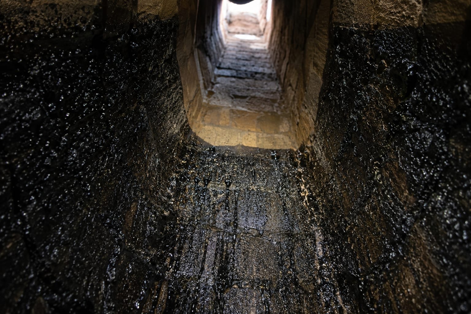 Creosote buildup coating the inside of a wood-burning chimney flue