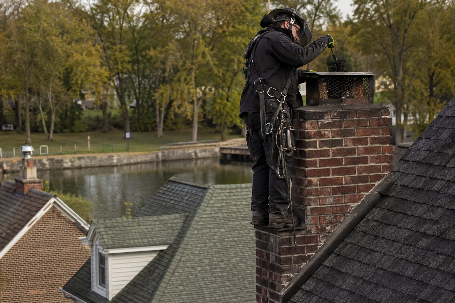 Chimney sweep servicing a historic village home chimney in Baldwinsville, NY