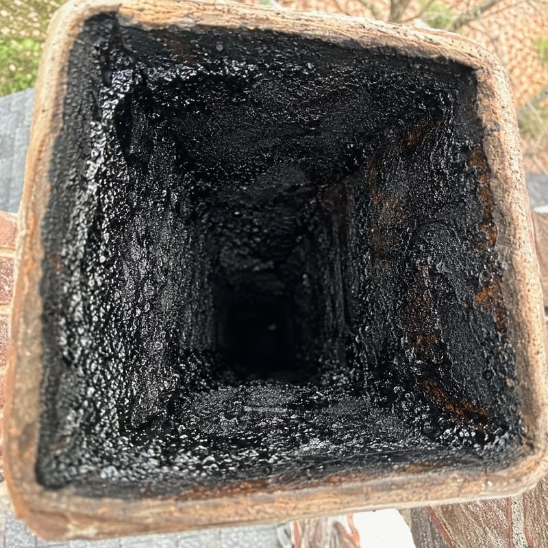 Glazed stage three creosote coating the inside of a flue before chimney cleaning in Syracuse, NY